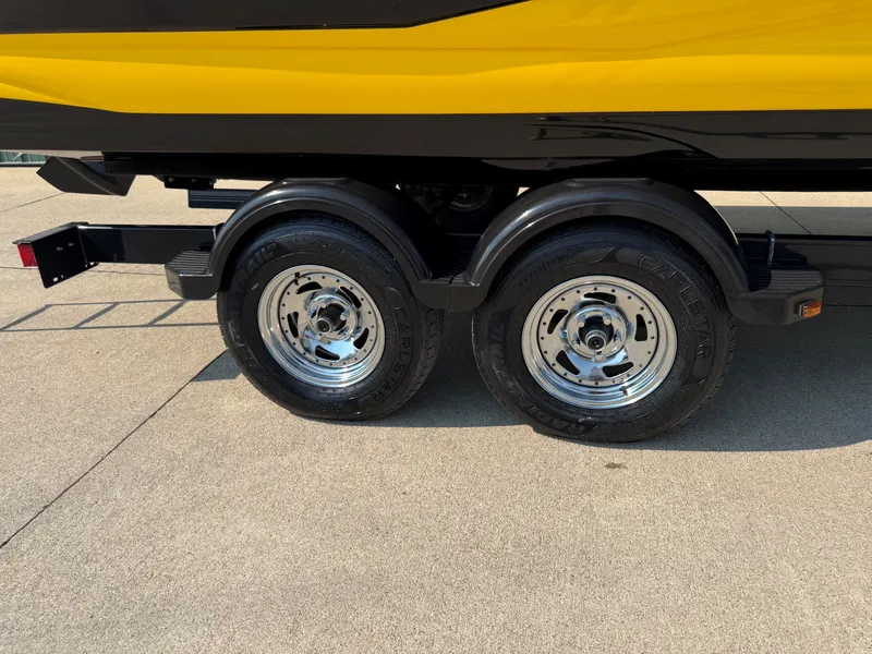 Slide: The Image of A yellow 2015 Crownline 235 SS on a trailer with shiny dual wheels. - 29
