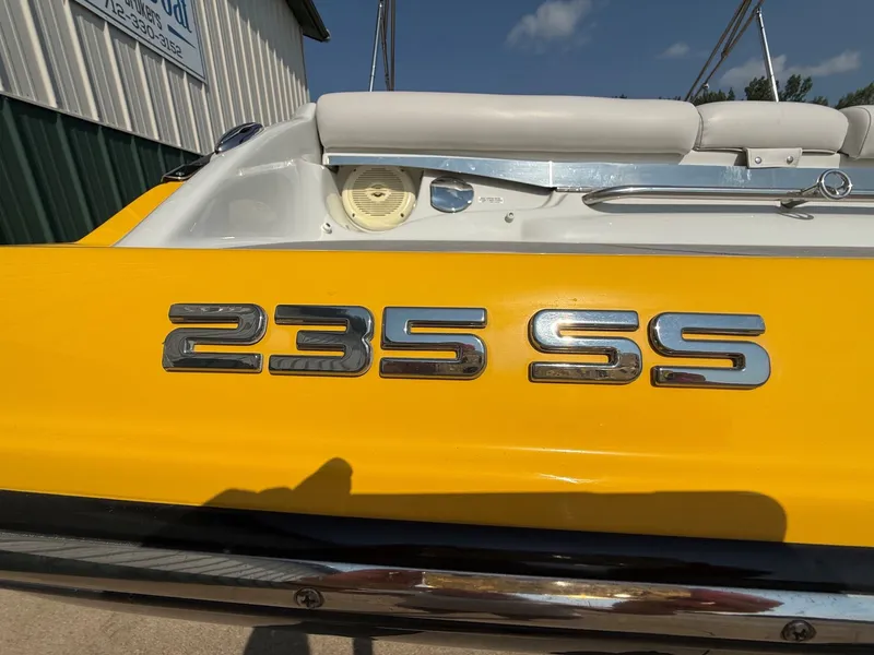 Slide: The Image of Close-up of the yellow Crownline 235 SS boat with chrome lettering on the stern. - 6