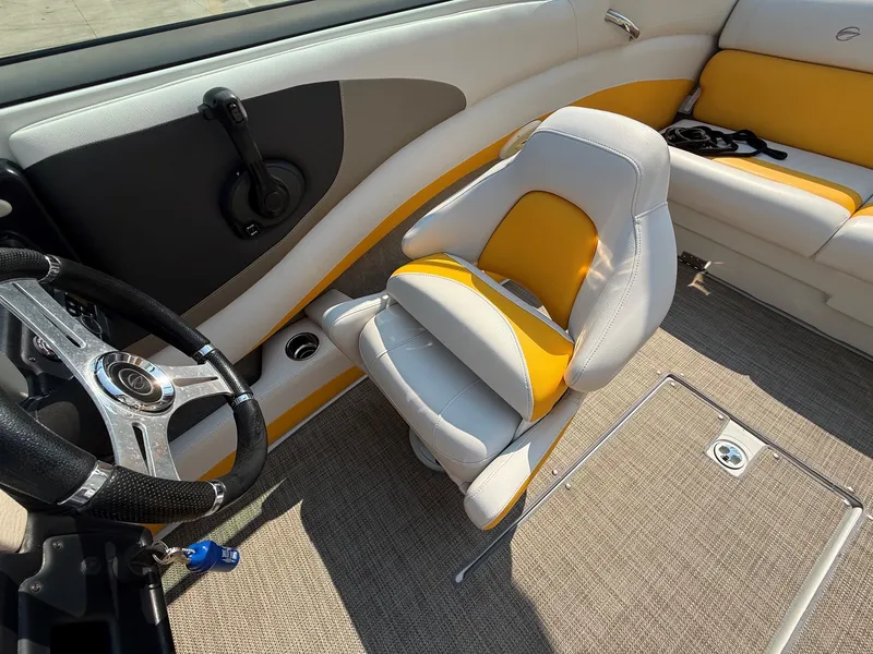Slide: The Image of The image shows the cockpit of a 2015 Crownline 235 SS with yellow and white seating. - 16