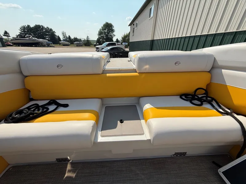 Slide: The Image of The image shows the stern of a 2015 Crownline 235 SS boat with yellow and white seating. - 23