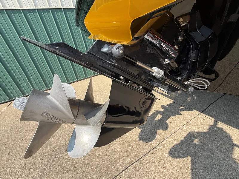 Slide: The Image of Close-up of a boat propeller and drive system, partially mounted in a yellow boat hull. - 8