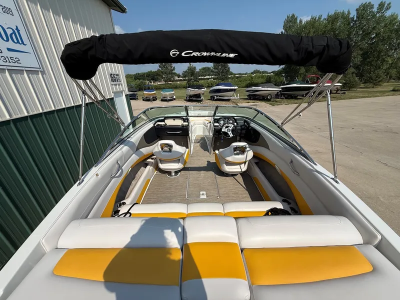 Slide: The Image of The image shows a 2015 Crownline 235 SS boat with yellow and white seating. - 10