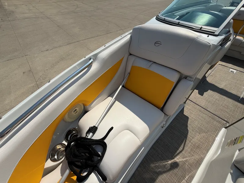 Slide: The Image of The image shows the cockpit of a 2015 Crownline 235 SS boat with white and yellow seating. - 14