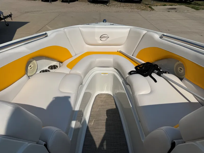 Slide: The Image of The image shows the bow area of a 2015 Crownline 235 SS boat with yellow and white upholstery. - 12