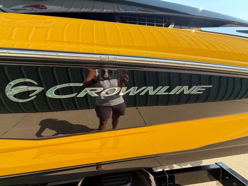Slide: The Image of Close-up of the shiny yellow hull of a 2015 Crownline 235 SS boat. - 5