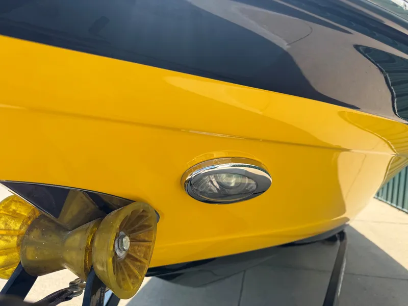 Slide: The Image of Close-up of a yellow hull on a Crownline 235 SS boat with a headlight. - 4