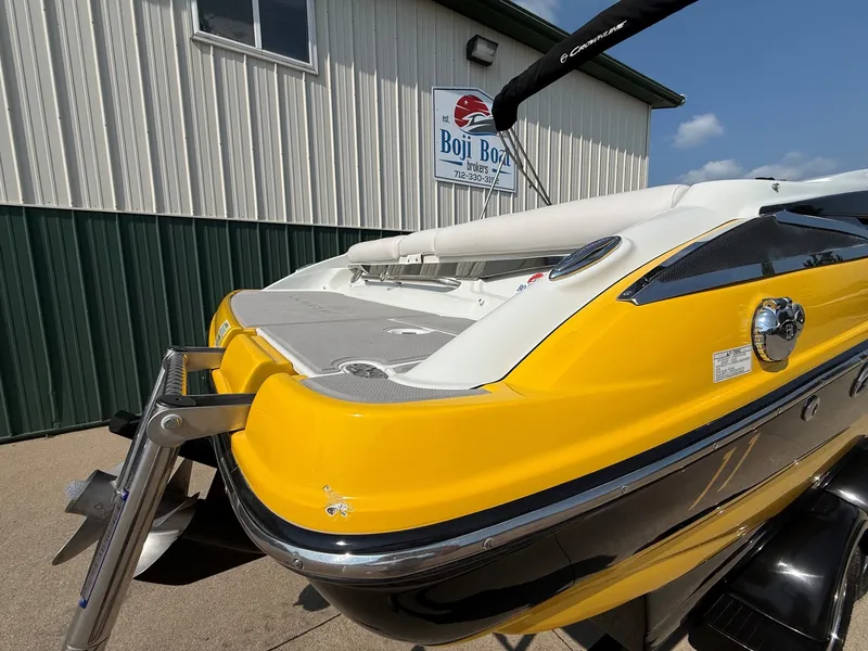 Slide: The Image of A yellow 2015 Crownline 235 SS boat on a trailer in front of a building. - 7