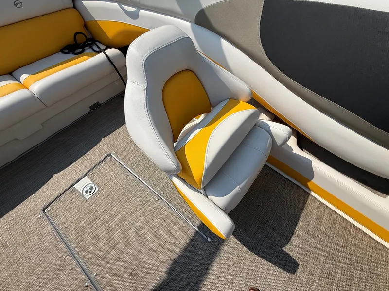 Slide: The Image of The interior of a 2015 Crownline 235 SS features a cushioned seat in yellow and gray. - 17