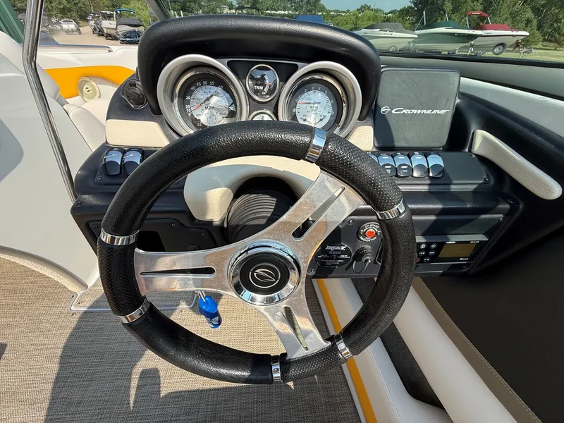 Slide: The Image of The image shows the cockpit of a 2015 Crownline 235 SS with a sleek steering wheel and gauges. - 20