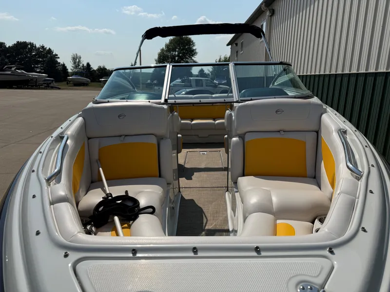 Slide: The Image of The image shows a 2015 Crownline 235 SS boat with yellow and white seating. - 3