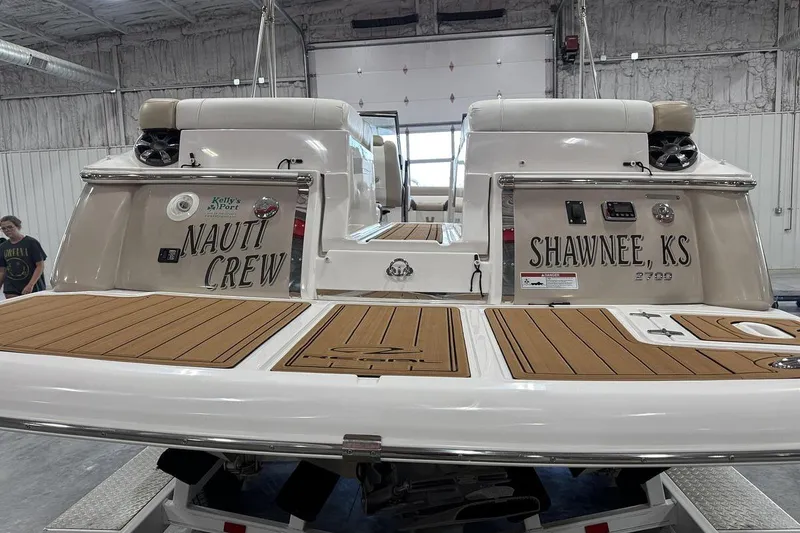 Slide: The Image of 2017 Regal 2700 Bowrider boat in a garage, featuring "Nauti Crew" and "Shawnee, KS" text. - 5