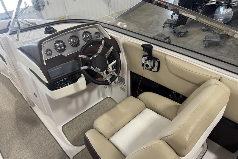 Slide: The Image of 2017 Regal 2700 Bowrider cockpit with beige seating and modern dashboard controls. - 11