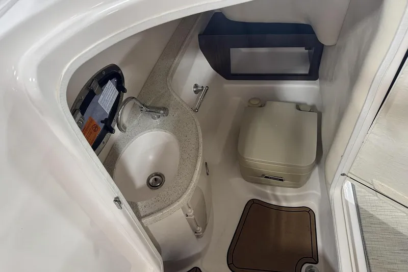 Slide: The Image of 2017 Regal 2700 Bowrider boat interior with sink and portable toilet. - 8