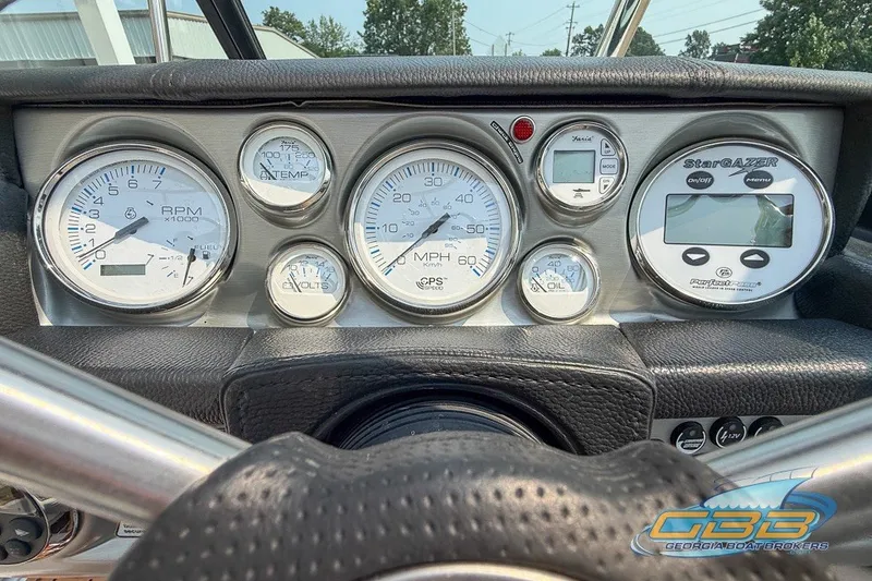 Slide: The Image of Dashboard of a 2008 Nautique Super Air Nautique 210 boat with gauges and controls. - 20