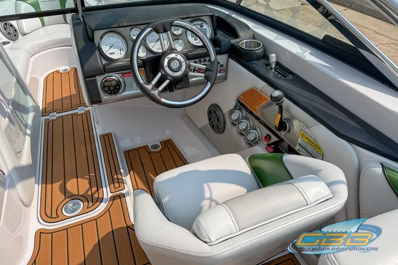 Slide: The Image of 2008 Nautique Super Air Nautique 210 boat interior with wood accents and modern dashboard. - 25
