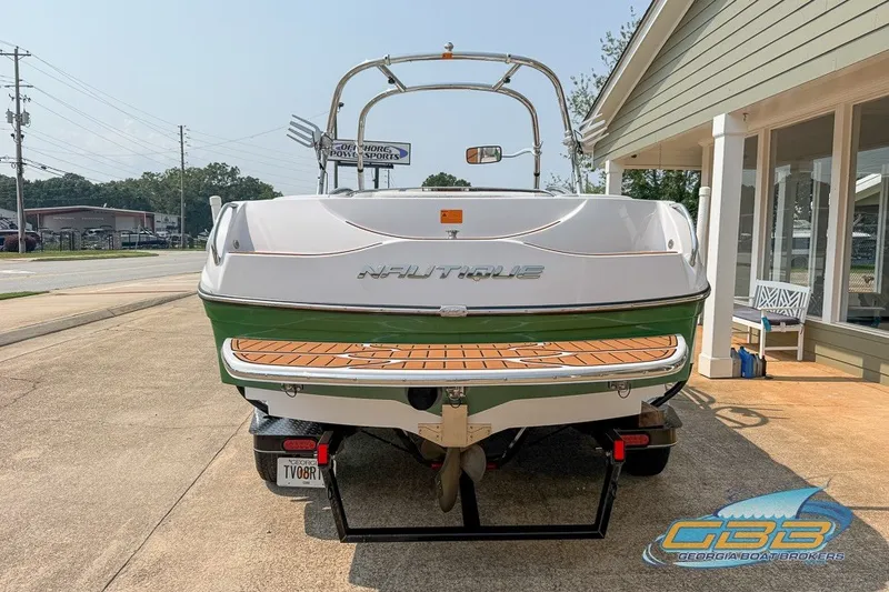 Slide: The Image of 2008 Nautique Super Air Nautique 210 boat on trailer, rear view, parked outside. - 3