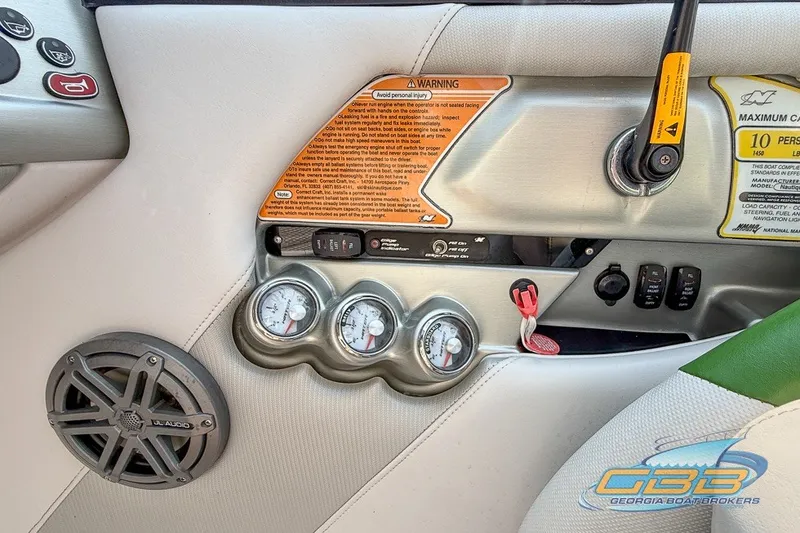 Slide: The Image of 2008 Nautique Super Air Nautique 210 dashboard with gauges, warning labels, and JL Audio speaker. - 36