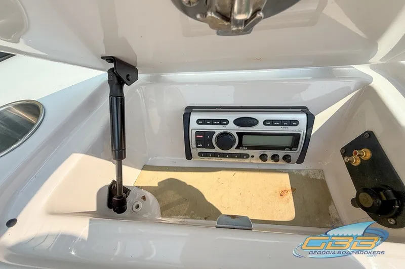 Slide: The Image of 2008 Nautique Super Air Nautique 210 boat stereo system in storage compartment. - 30