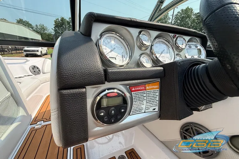 Slide: The Image of Dashboard of a 2008 Nautique Super Air Nautique 210 boat with gauges and controls. - 34