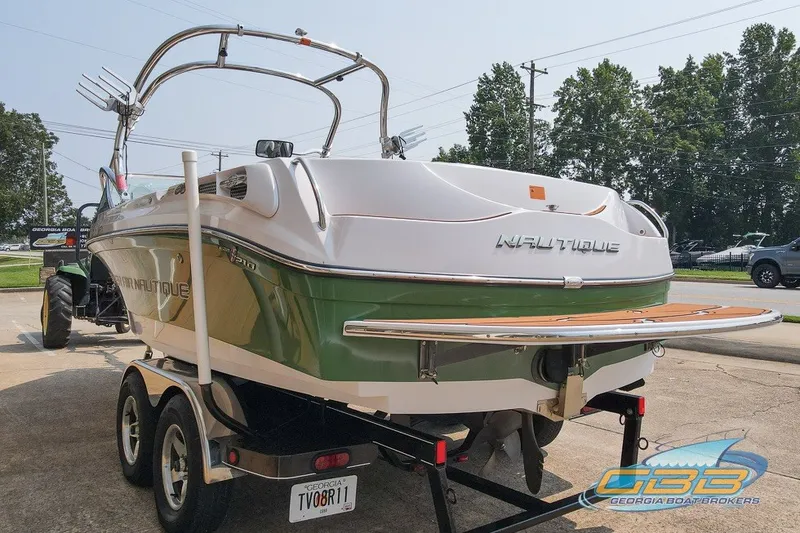 Slide: The Image of 2008 Nautique Super Air Nautique 210 boat on trailer, rear view, green and white design. - 27