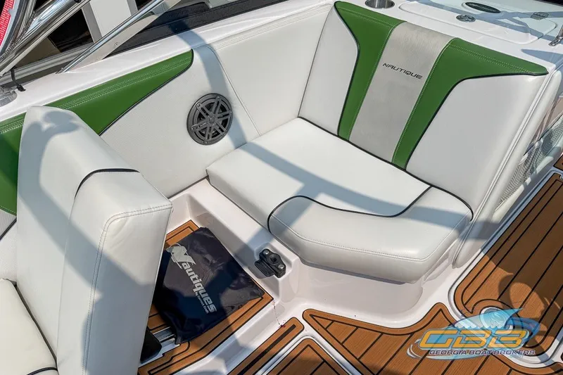Slide: The Image of 2008 Nautique Super Air Nautique 210 boat interior with green and white seating. - 24