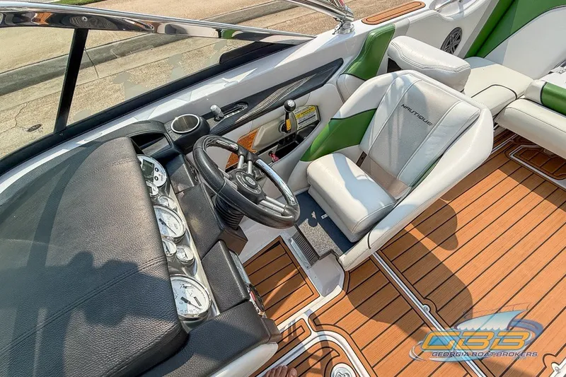 Slide: The Image of 2008 Nautique Super Air Nautique 210 boat interior with steering wheel and gauges. - 21