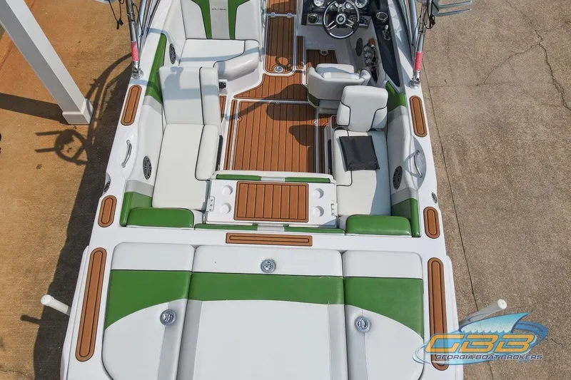 Slide: The Image of 2008 Nautique Super Air Nautique 210 boat interior with green and white seating. - 12