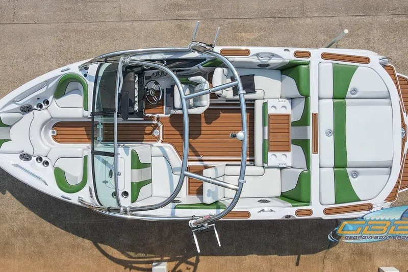 Slide: The Image of 2008 Nautique Super Air Nautique 210 boat, aerial view, green and white interior, sleek design. - 13