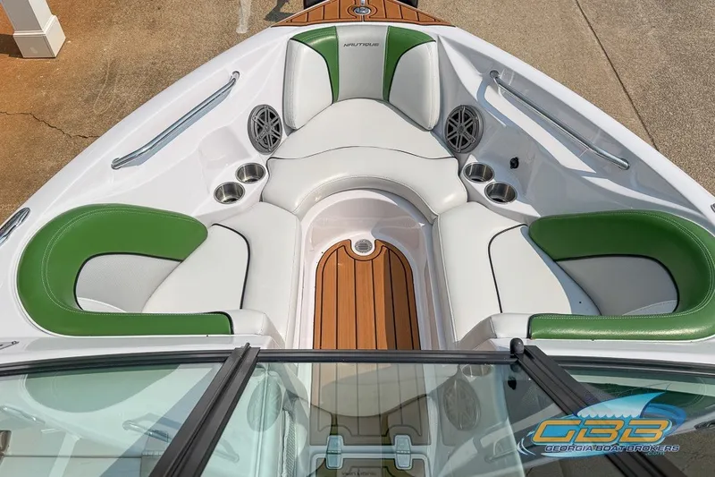 Slide: The Image of 2008 Nautique Super Air Nautique 210 boat interior with green and white seating. - 23