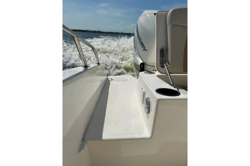 Slide: The Image of Boston Whaler 270 Dauntless 2017 boat cruising on water, rear view with Mercury engine. - 25