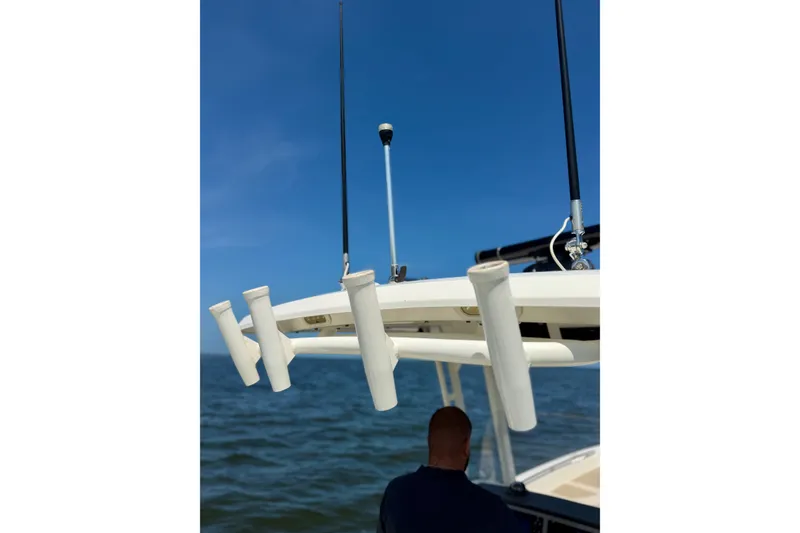 Slide: The Image of Boston Whaler 270 Dauntless 2017 boat with rod holders, ocean backdrop, clear blue sky. - 21