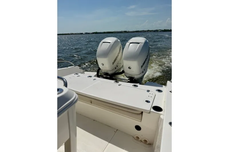 Slide: The Image of 2017 Boston Whaler 270 Dauntless with dual Mercury outboard engines on open water. - 23