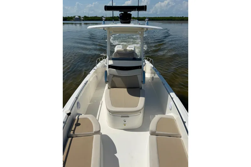 Slide: The Image of 2017 Boston Whaler 270 Dauntless boat cruising on calm water, featuring spacious seating. - 17