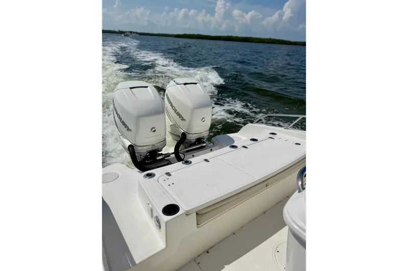 Slide: The Image of 2017 Boston Whaler 270 Dauntless with dual Mercury outboard engines cruising on open water. - 27