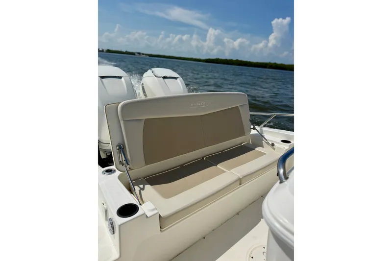 Slide: The Image of 2017 Boston Whaler 270 Dauntless boat with beige seating, cruising on open water. - 24