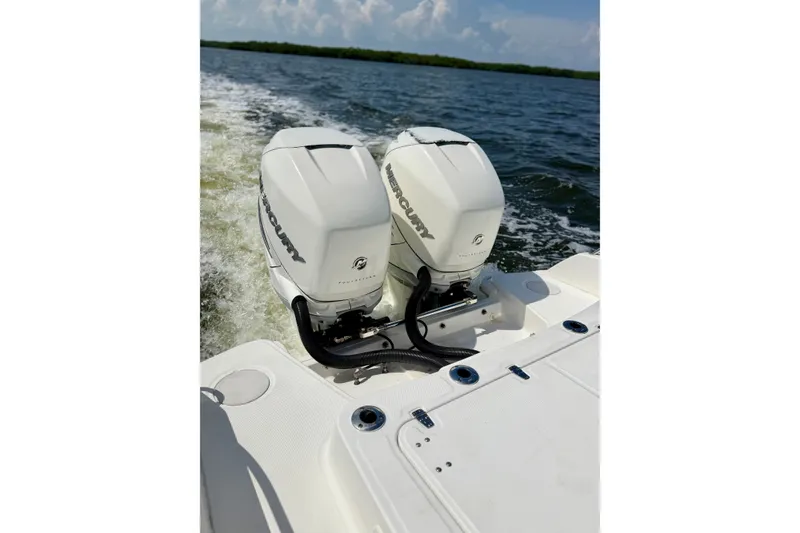 Slide: The Image of Twin Mercury engines on a 2017 Boston Whaler 270 Dauntless cruising on open water. - 26