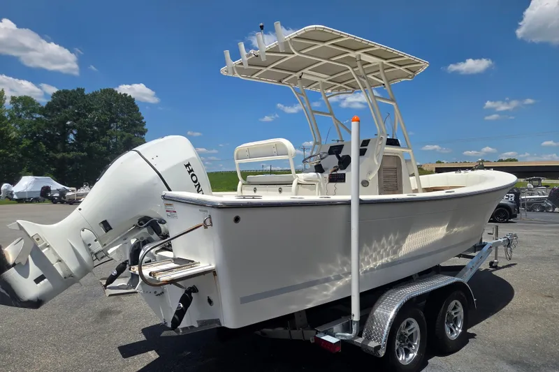 Slide: The Image of 2021 Vanquish 23 CC boat on trailer with Honda outboard motor under clear blue sky. - 4