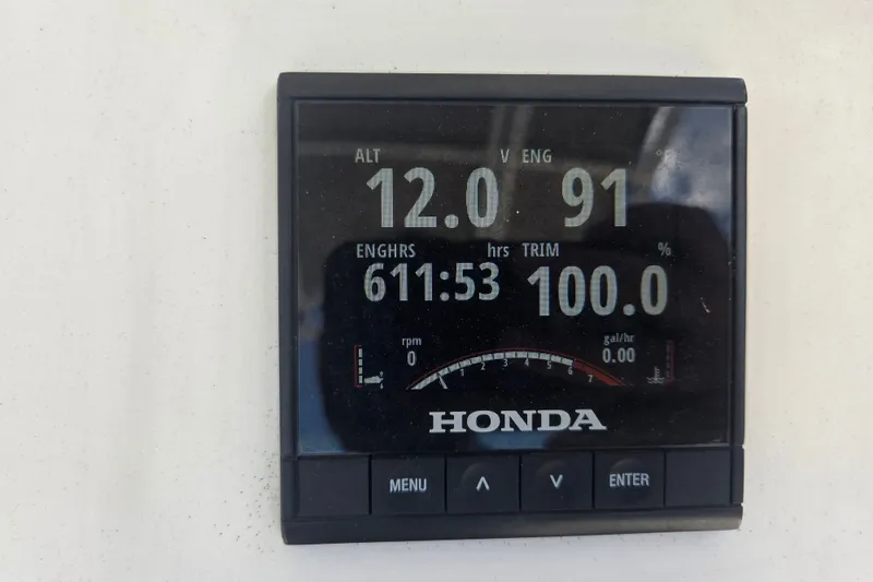 Slide: The Image of Honda engine display showing 611.53 hours, 12.0 ALT, 91 V ENG, on Vanquish 23 CC. - 12