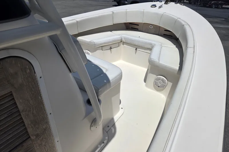 Slide: The Image of 2021 Vanquish 23 CC boat interior with white seating and speaker detail. - 6