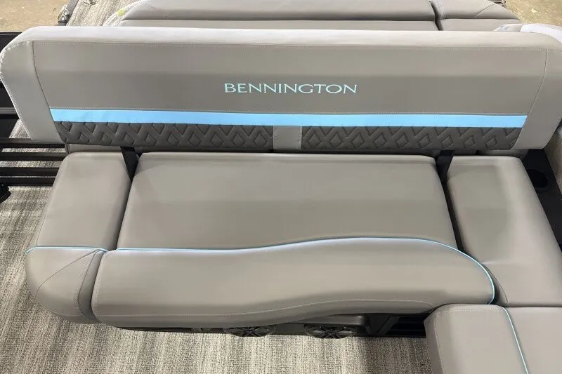 Slide: The Image of 2027 Bennington 22 M Swingback boat seat with gray upholstery and blue accents. - 14