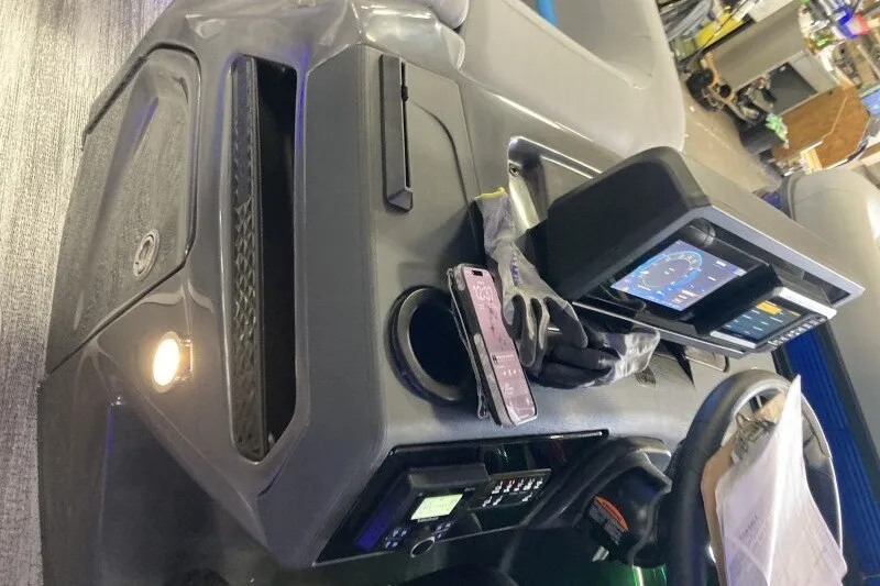 Slide: The Image of Dashboard of a 2027 Bennington 22 M Swingback with navigation display and smartphone holder. - 17