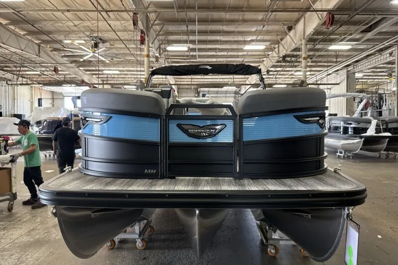 Slide: The Image of 2027 Bennington 22 M Swingback pontoon boat in a factory setting. - 3