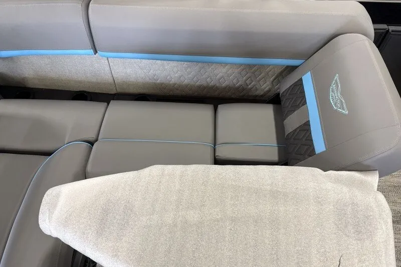 Slide: The Image of 2027 Bennington 22 M Swingback boat interior with gray and blue seating. - 13