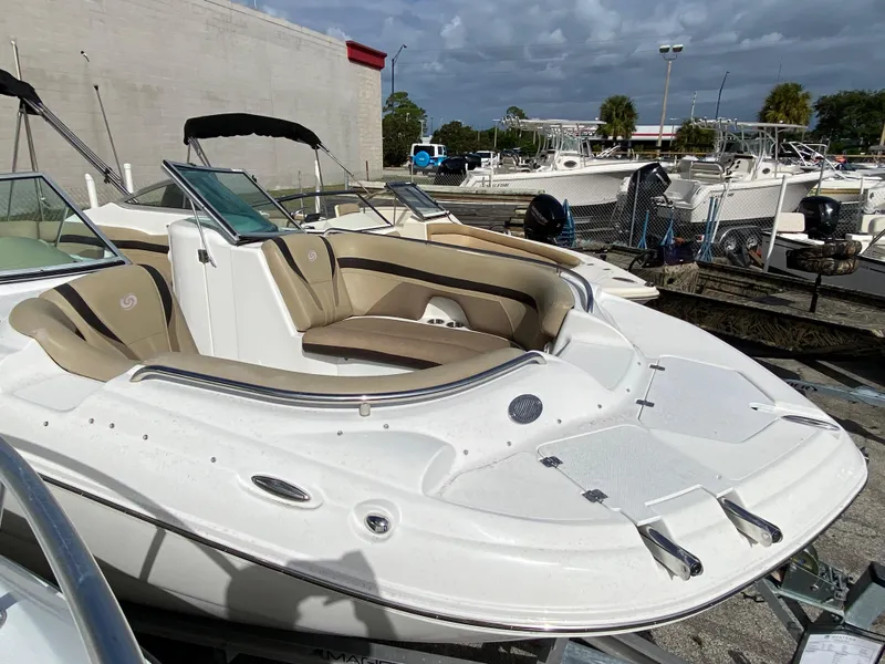Slide: The Image of 2019 Hurricane SD2200 boat with beige seating in a marina. - 4