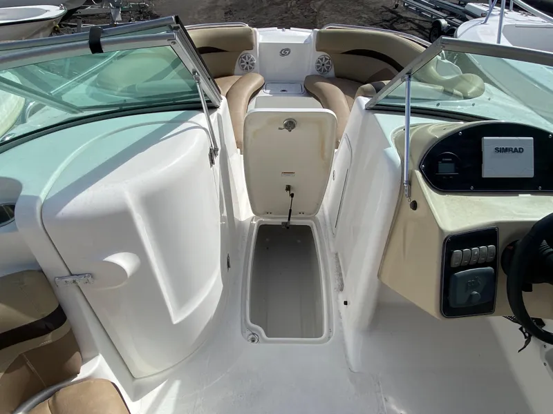 Slide: The Image of 2019 Hurricane SD2200 boat interior with beige seating and Simrad navigation system. - 12