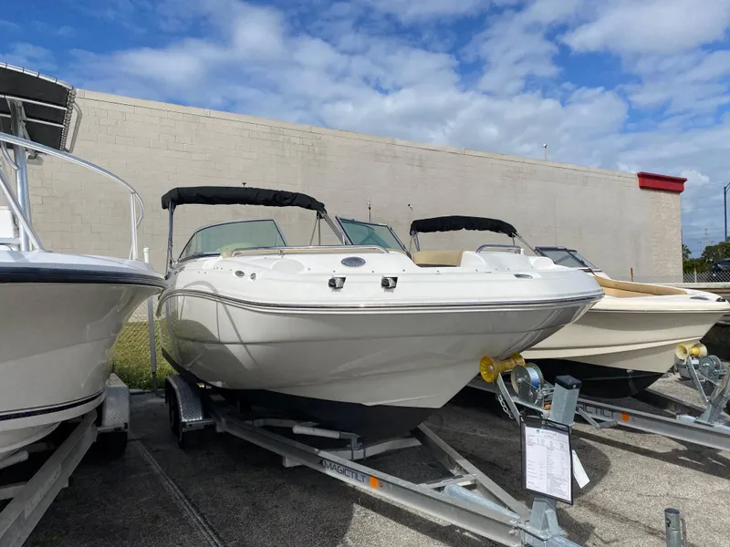 Slide: The Image of 2019 Hurricane SD2200 boat on trailer under blue sky. - 2