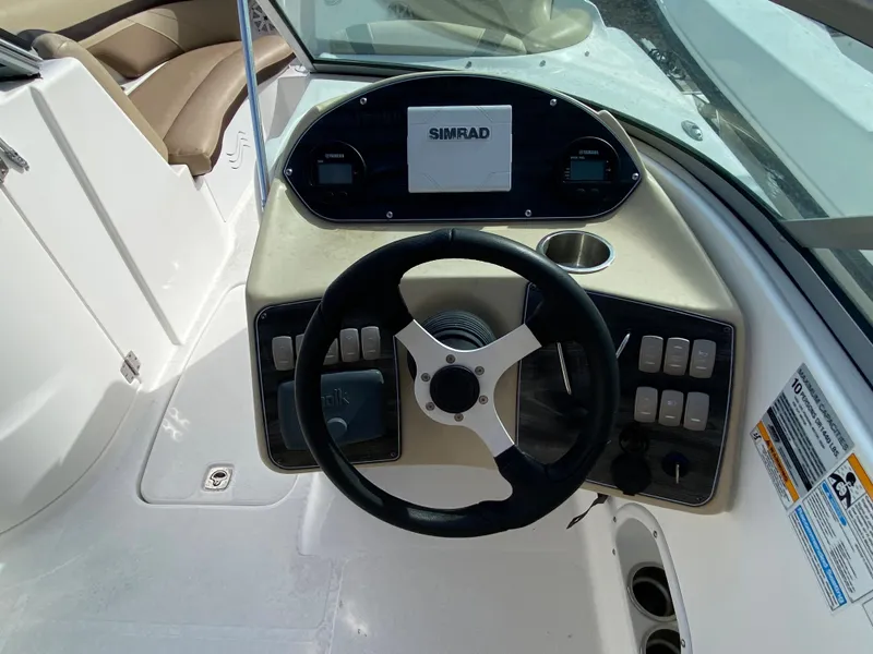 Slide: The Image of 2019 Hurricane SD2200 boat dashboard with steering wheel and Simrad display. - 8
