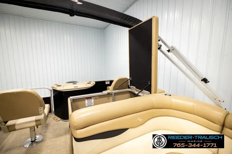Slide: The Image of 2018 Bennington SX RF pontoon boat interior with beige seating and storage compartments. - 26