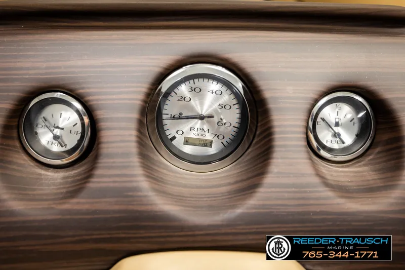 Slide: The Image of Dashboard gauges of a 2018 Bennington SX RF boat, featuring RPM, trim, and fuel indicators. - 35