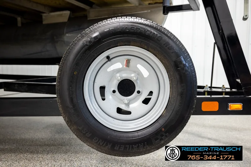 Slide: The Image of Trailer wheel of a 2018 Bennington SX RF pontoon boat, featuring a sturdy tire and rim. - 52